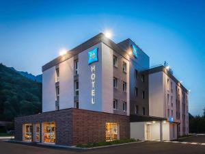 a hotel with a sign on the front of it at Ibis Budget Sallanches in Sallanches