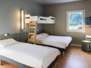 a room with two bunk beds and a window at Ibis Budget Sallanches in Sallanches +42 photos