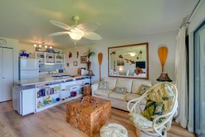a living room with a couch and a kitchen at Beachside Molokai Condo w/ Lanai & Pool Access! in Kaunakakai