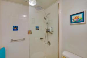 a bathroom with a shower with a glass door at Beachside Molokai Condo w/ Lanai & Pool Access! in Kaunakakai +16 photos