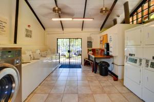 a large laundry room with a washer and dryer at Beachside Molokai Condo w/ Lanai & Pool Access! in Kaunakakai