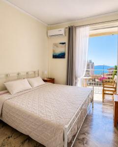 a bedroom with a bed with a view of the ocean at Farniente Tolo in Tolo