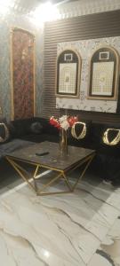 a living room with a table and a couch at Khokhar house in Lahore