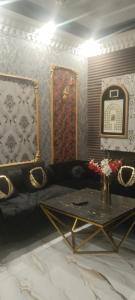 a living room with a couch and a table at Khokhar house in Lahore