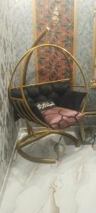 a curved chair in a room with a wall at Khokhar house in Lahore