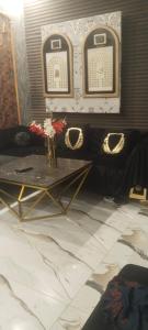 a living room with a table and a fireplace at Khokhar house in Lahore