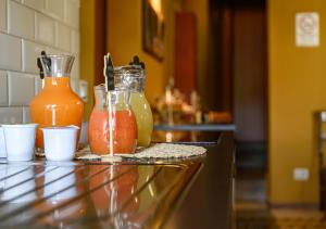 a counter with two jars of juice on it at B&B Locanda Cistercense in San Martino al Cimino +24 photos