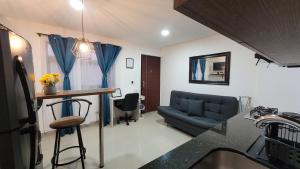 a living room with a couch and a table at Estudio cerca a puerta del norte in Bello
