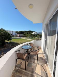 a balcony with chairs and a table and a view at Duraku Apartments in Ulcinj
