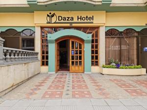 a hotel entrance with a door and a sign that reads daza hotel at Daza Hotel in Paipa