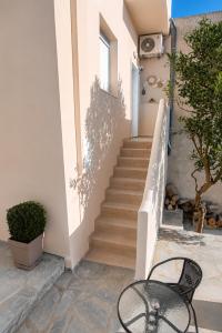 a black chair sitting in front of a staircase at Nook Athens Airport in Spata