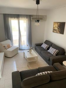 a living room with a couch and a table at Evelyn House in Samos