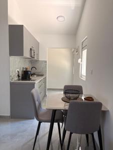 a kitchen with a table and chairs in a room at Sea&Forest view in Buljarica
