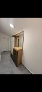 a room with a mirror on a white wall at Sea&Forest view in Buljarica +1 photo