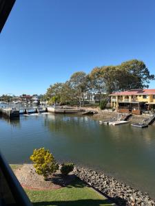 a view of a river with houses and a dock at Bribie Waterways Motel in Bongaree +109 photos