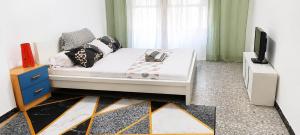 a bedroom with a white bed and a television at habitacion 1 in Zaragoza +3 photos