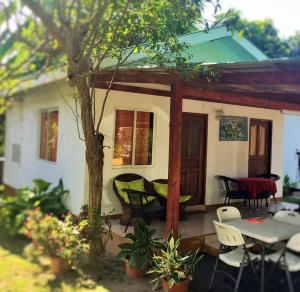 a house with a table and chairs in front of it at Chalets Anse Possession in Baie Sainte Anne