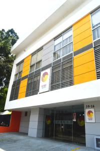 a building with yellow and orange at Hotel Mare Apartasuite in Cali