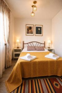 a bedroom with a bed with two towels on it at Căsuța Sofia in Sulina