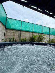 a large pool of water in front of a building at Altima Arenal Volcano View in Tanque