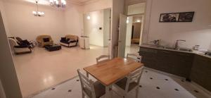 a kitchen with a table and chairs and a sink at Appartement Alger in Alger +8 photos