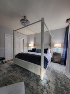 a bedroom with a large canopy bed with blue pillows at Terrace On Main Street in Murphys