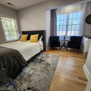 a bedroom with a bed and two chairs and a table at Terrace On Main Street in Murphys