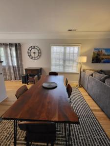 a living room with a wooden table and a couch at Terrace On Main Street in Murphys +15 photos