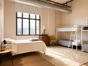 a bedroom with two bunk beds and a window at Hostel du Nord in Duluth