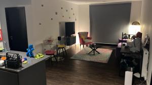 a living room with a couch and a table and chairs at Greenford Quay in Harrow on the Hill