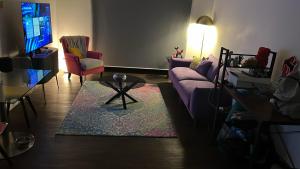 a living room with a couch and a table at Greenford Quay in Harrow on the Hill