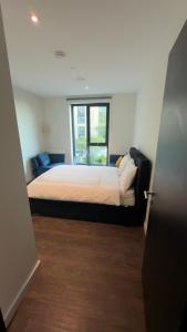 a bedroom with a bed and a window at Greenford Quay in Harrow on the Hill