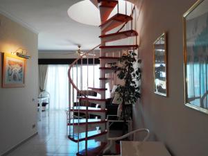 a wooden spiral staircase in a living room at Royal Golf Park Club in San Miguel de Abona