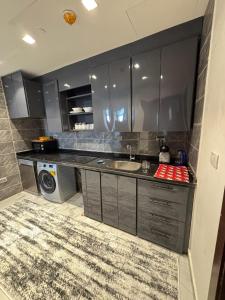 a kitchen with a sink and a washing machine at New Alamen Towers in El Alamein +4 photos