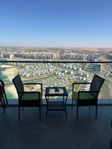 a table and chairs on a balcony with a view at New Alamen Towers in El Alamein
