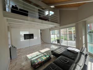a living room with a couch and a tv at Villa Encanto in Albstadt