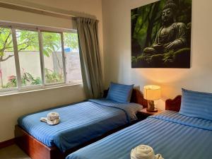 a bedroom with two beds and a large window at Lotus Haven Villa in Siem Reap +186 photos