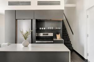 a kitchen with a staircase in the background at Ida Phoenix in Phoenix