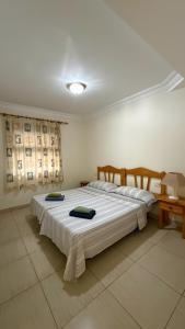 a bedroom with two beds with white sheets at Los Cristianos Plaza Centre suite in Los Cristianos +32 photos
