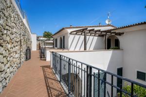 a balcony of a white building with a black railing at Casa Andreale in Capoliveri