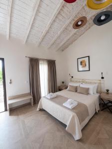 a bedroom with a large bed in a room at Villa Don Kostangelo in Nikiana +73 photos
