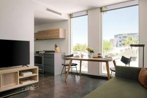 a living room with a table and a large window at Ida Phoenix in Phoenix