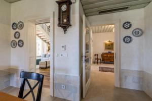 a hallway with a clock on the wall at Villa Avola Bol Exclusive Beach Access in Bol