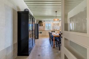 a kitchen and dining room with a table and chairs at Villa Avola Bol Exclusive Beach Access in Bol