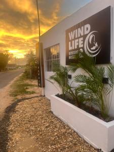 a building with a sign on the side of a road at Wind Life Home in Itarema