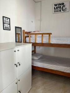 a room with two bunk beds and a counter at Wind Life Home in Itarema +9 photos