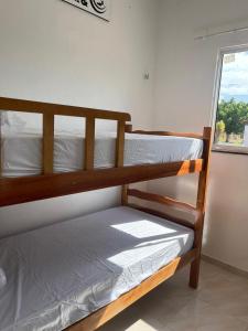 a pair of bunk beds in a room with a window at Wind Life Home in Itarema