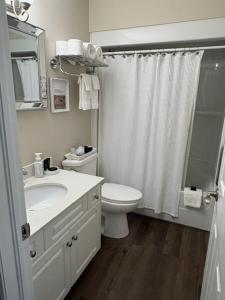 a white bathroom with a sink and a toilet at Casa Blanca Boutique Bed & Breakfast in Niagara-on-the-Lake +23 photos