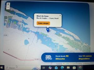 a computer screen with a map and a sign at Wind Life Home in Itarema