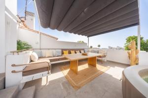 a living room with a couch and a table on a balcony at Villa Cobo in Torremolinos